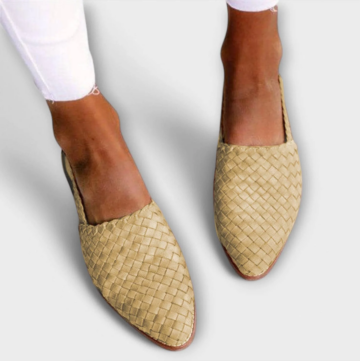 Beige woven pointed-toe slip-ons worn with white frayed jeans, seen from above. 5