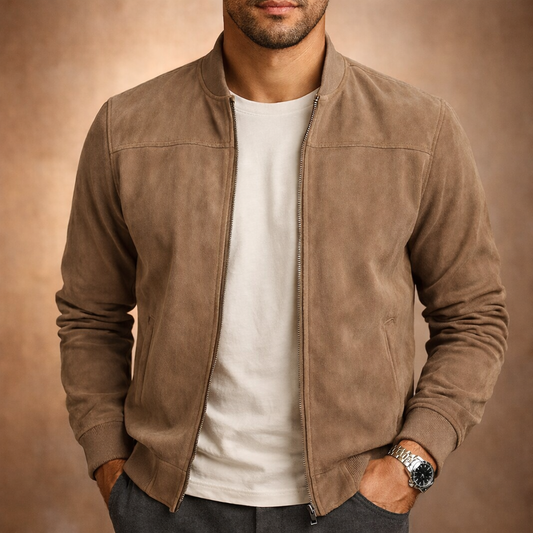 Front view of a man wearing the jacket in tan suede-look fabric, unzipped over a white t-shirt, hands in pockets. 1