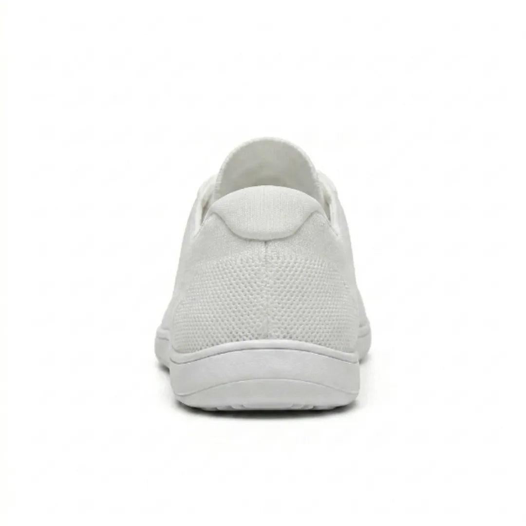 Rear view of a white knitted trainer showing the heel tab, textured mesh upper and thin flat sole. 45
