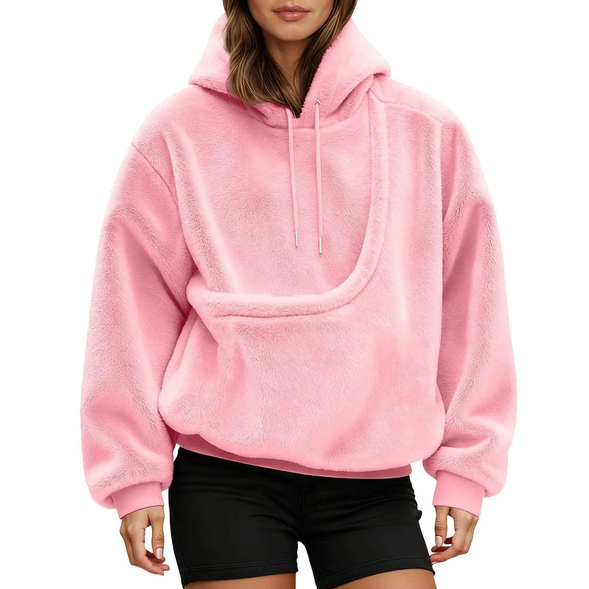 Front view of a pink fluffy hoodie on a model, showing the empty curved kangaroo pouch and drawstring hood. 12