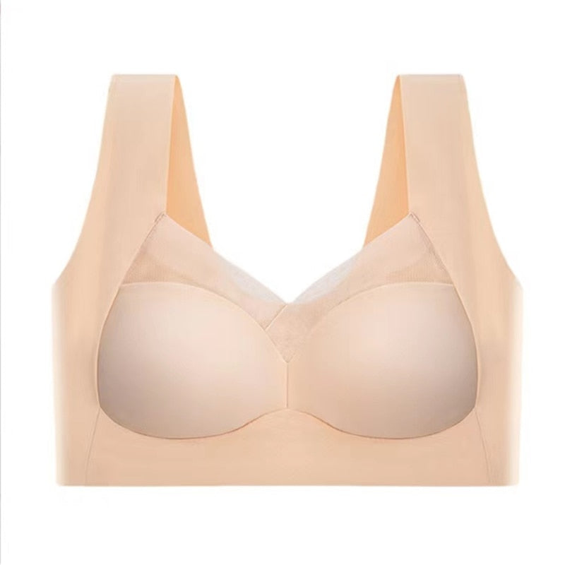 Beige seamless bra laid flat against a white background, showing the mesh neckline panel, wide straps and smooth cups. 12