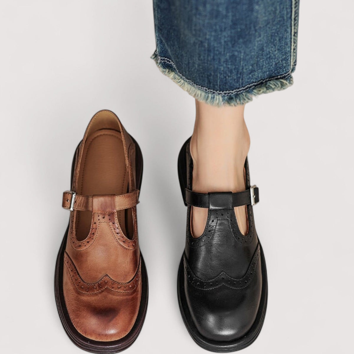 Tan and black versions side by side from above, the black pair worn with frayed blue jeans. 7
