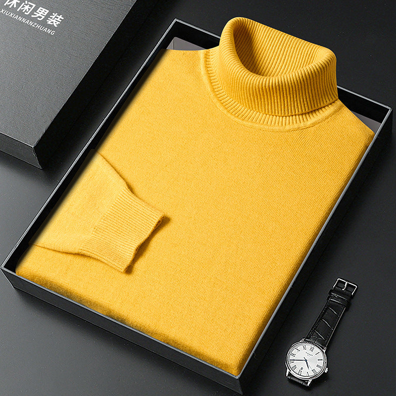 Folded yellow roll-neck jumper with ribbed collar and cuff in a black box, with a white-faced wristwatch and lidded gift box. 9