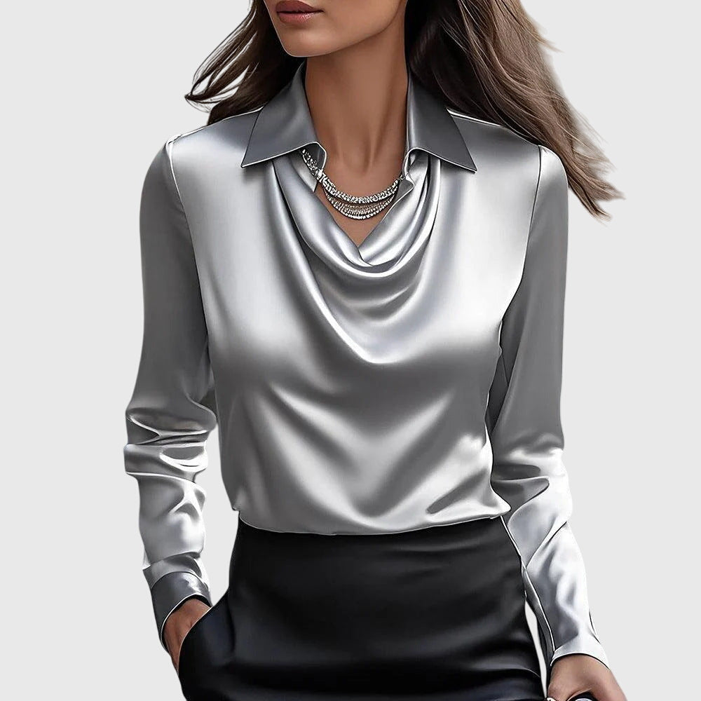 Model wears the silver-grey satin blouse with soft draped cowl neck and pointed collar, paired with a black skirt. 2