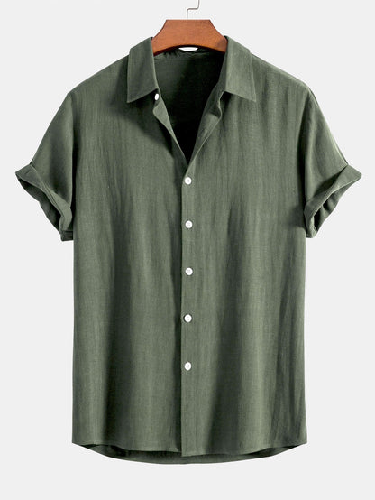 Olive green short-sleeved shirt on a wooden hanger, front view with white buttons and rolled sleeve cuffs. 5