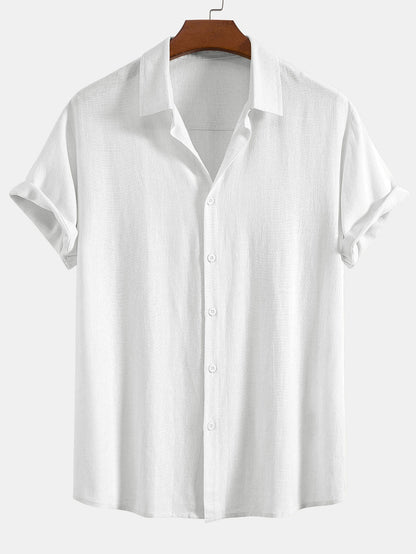 White short-sleeved shirt on a wooden hanger, front view with a textured weave, matching white buttons and cuffed sleeves. 6