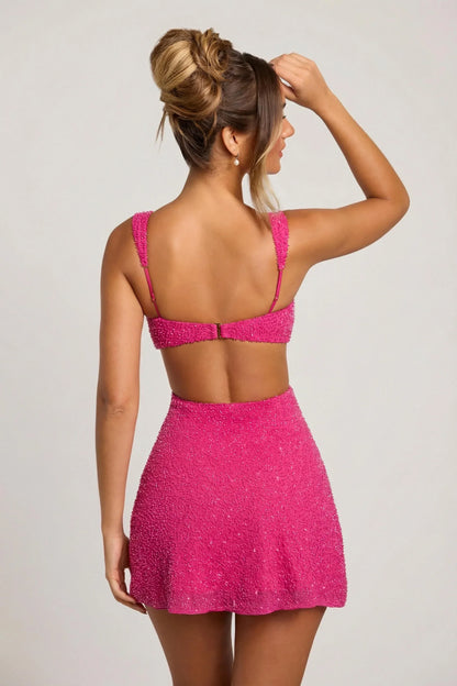 Close back view of the dress, showing the open back, thin adjustable straps, small clasp fastening and beaded A-line skirt. 3