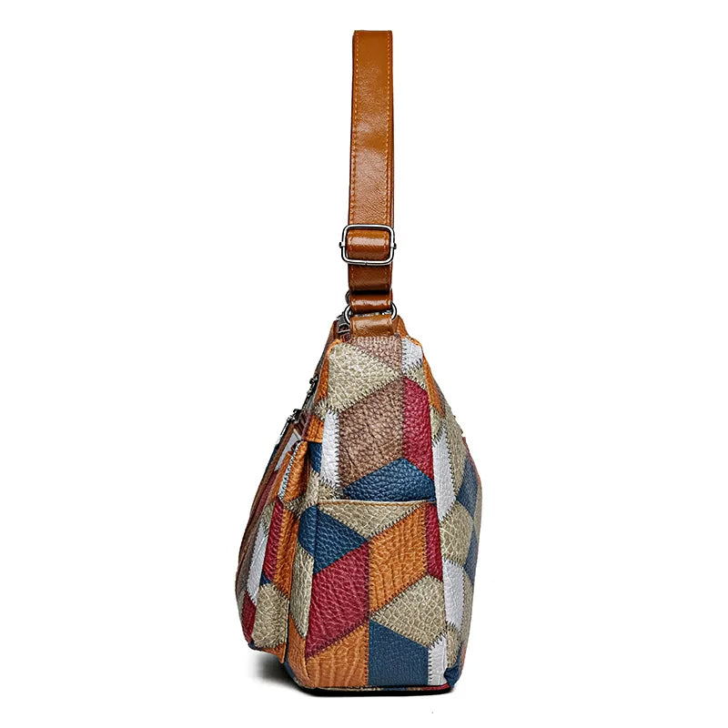 Side view of the bag showing the strap with metal buckle and the open pocket on the patchwork panel. 11