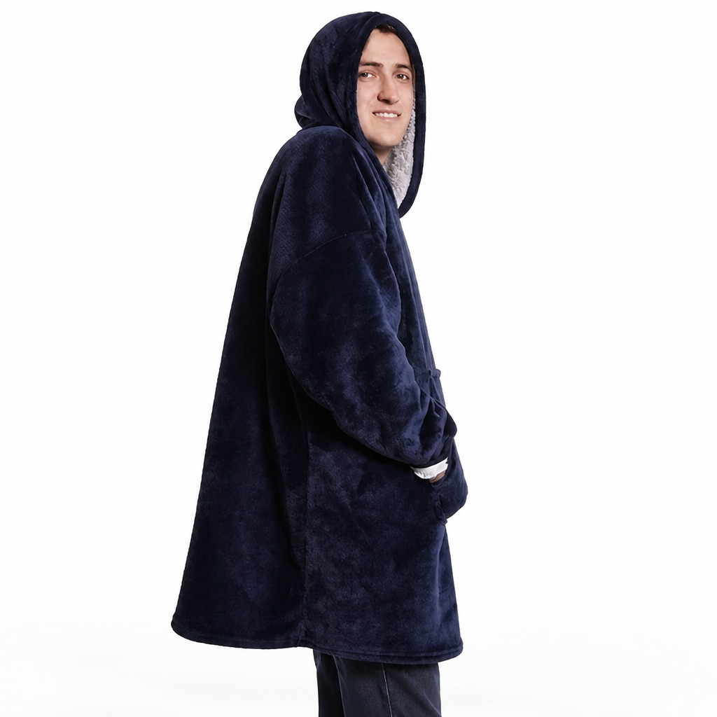 Smiling man in a navy blue hoodie blanket seen from the side, hood up, with one hand in the pocket. 3