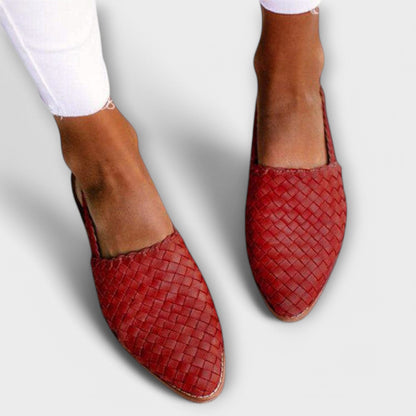 Red woven pointed-toe slip-ons worn with white frayed jeans, seen from above. 3
