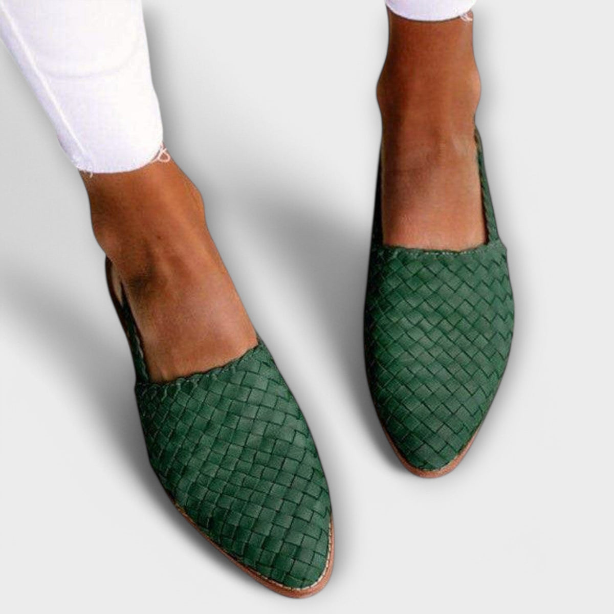 Dark green woven pointed-toe slip-ons worn with white frayed jeans, seen from above. 2