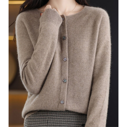 Taupe cardigan worn by a model with one hand raised to her chin, over a houndstooth skirt, showing the soft brushed knit. 10