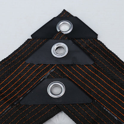 Close-up of three metal eyelets set in black reinforced triangular corner patches on the woven black hem of the tarpaulin. 5