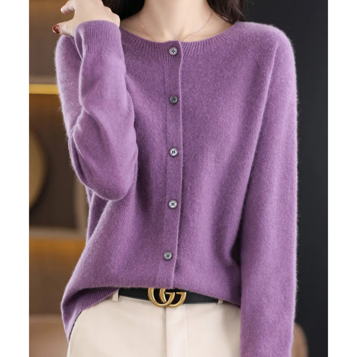 Lilac-purple cardigan on a model, buttoned to the round neckline, with raglan sleeves, ribbed cuffs and a black belt. 9
