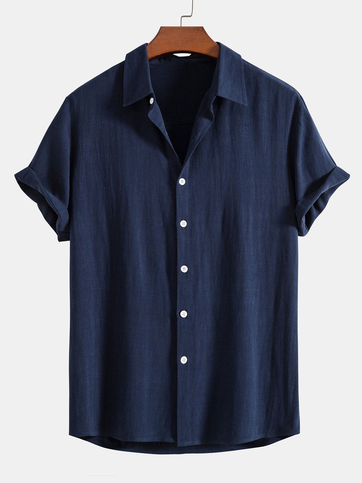 Navy blue short-sleeved shirt on a wooden hanger, front view with white buttons and cuffed sleeves. 4