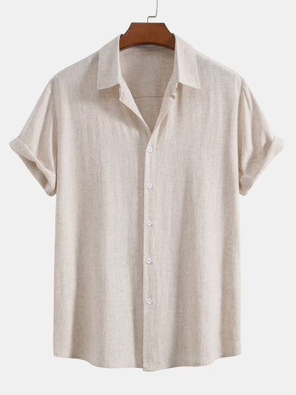 Natural oatmeal-coloured short-sleeved shirt on a wooden hanger, front view showing its flecked linen-look texture and white buttons. 3