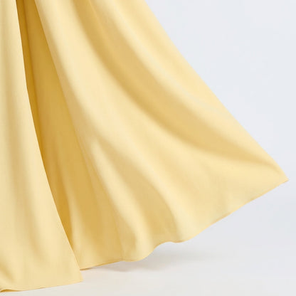 Close-up of the flowing pale yellow skirt hem, showing the soft, lightweight fabric. 6