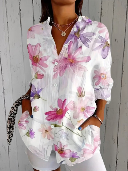 Model wearing the white shirt with soft watercolour daisies in pink and lilac, buttoned with a relaxed fit. 4