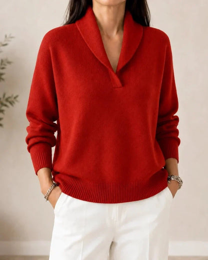 Front view of the jumper in bright red on a model wearing white trousers, showing the V-neck with shawl collar. 10