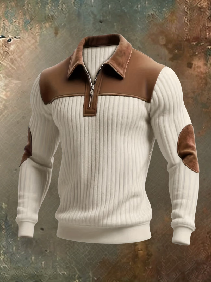 Cream ribbed quarter-zip jumper with brown suede-look shoulder panel, collar and elbow patches, displayed front-on against a textured background. 2