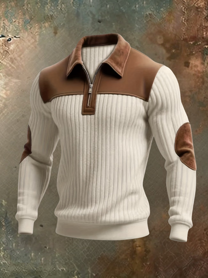 Cream ribbed quarter-zip jumper with brown suede-look shoulder panel, collar and elbow patches, displayed front-on against a textured background. 2
