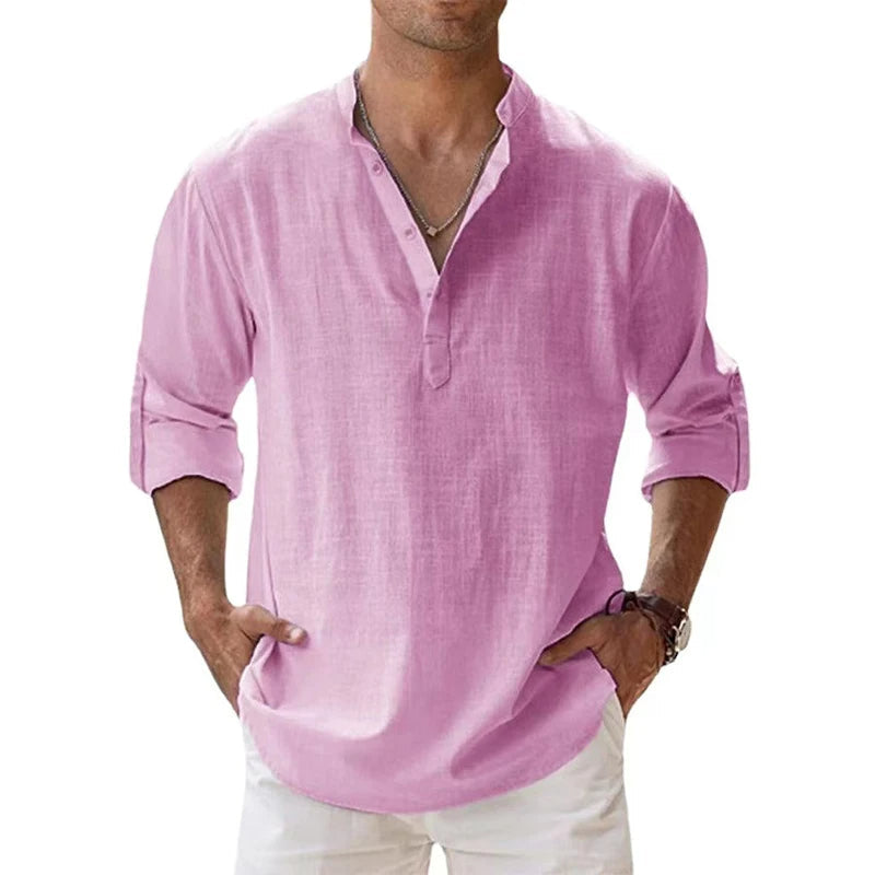 Model wearing the pink Henley shirt with rolled-up sleeves, a short button placket and white trousers. 3