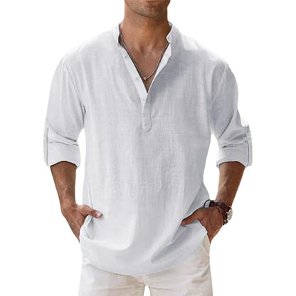 Model wearing the white Henley shirt with a relaxed fit, rolled sleeves and light trousers. 4
