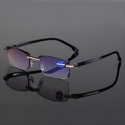Rimless glasses with black arms standing open on a reflective grey surface, with a strength sticker on one lens. 6