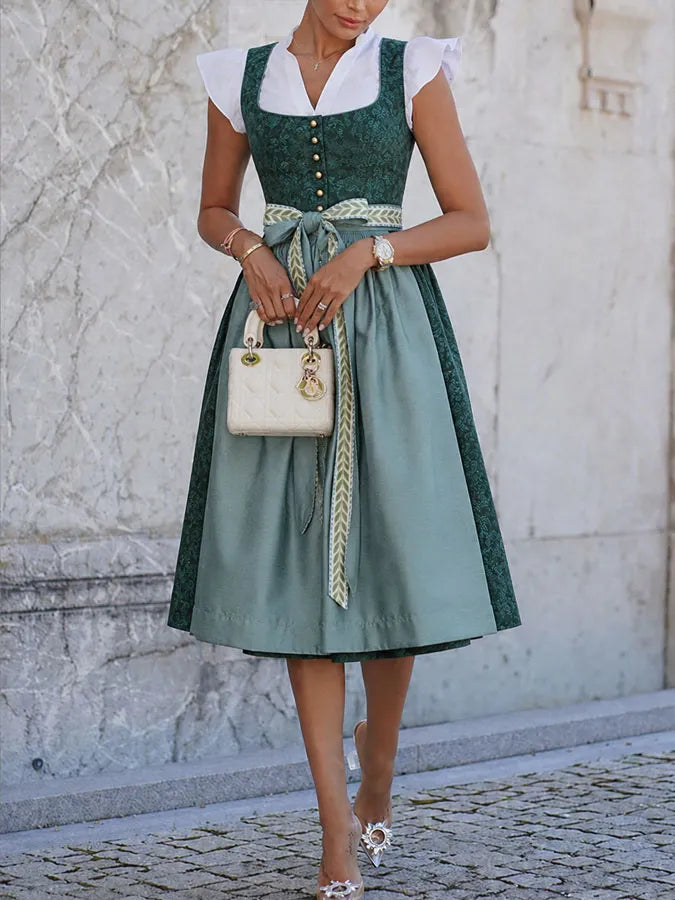 Full-length view of the dress from the neck down on a model, with buttoned bodice, bow at the waist and mid-calf skirt. 4
