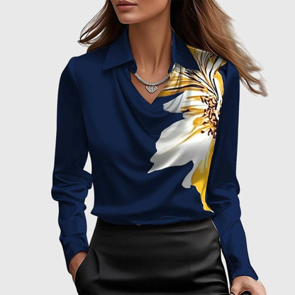 Model wears the navy satin blouse with a large white and yellow flower printed on one shoulder, with black skirt. 8