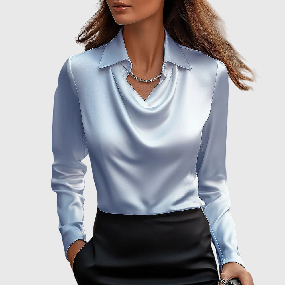 Model wears the pale blue satin blouse with draped cowl neck and collar, tucked into a black skirt. 4