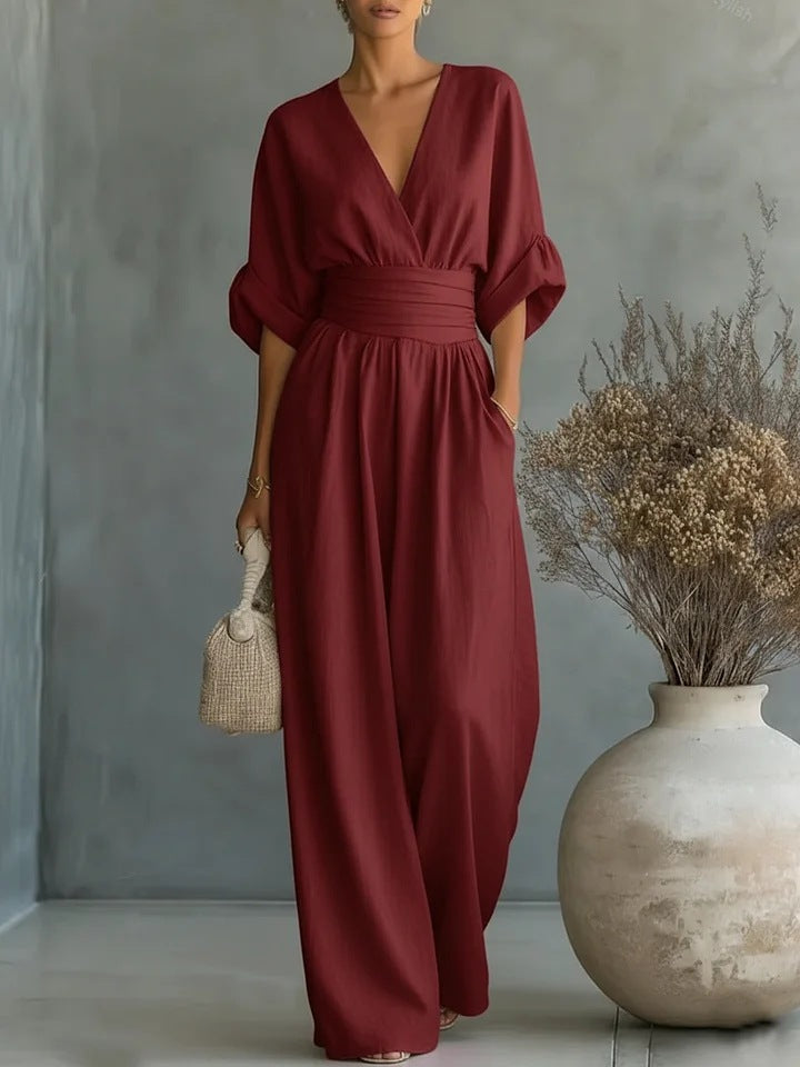 Same jumpsuit in deep burgundy red, front view showing the V-neckline, cuffed sleeves and flowing wide legs. 4