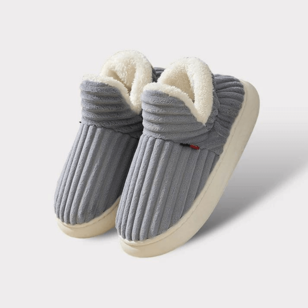 Pair of grey ribbed fleece-lined slippers with thick cream soles, shown on a plain light background. 20