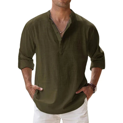 Model wearing the olive green Henley shirt with a button neck, rolled sleeves and white trousers. 8