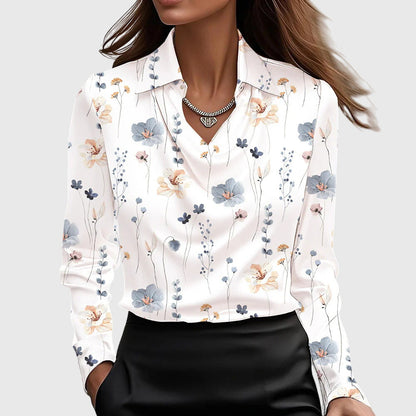 Model wears the white satin blouse with a delicate scattered print of small blue, peach and pink flowers and stems. 9