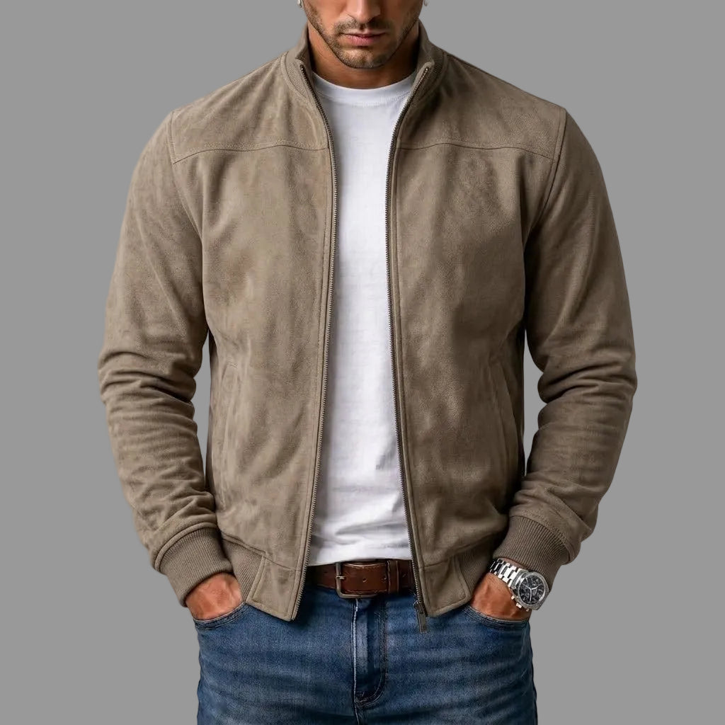 Taupe suede bomber with ribbed cuffs and hem, worn unzipped over a white t-shirt, jeans and brown belt. 2