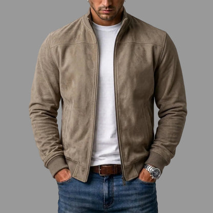 Taupe suede bomber with ribbed cuffs and hem, worn unzipped over a white t-shirt, jeans and brown belt. 2