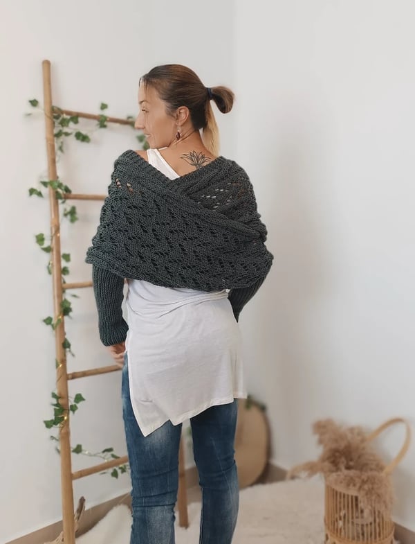 Back view of the dark grey wrap crossing over the shoulders, worn with a white top and jeans. 6