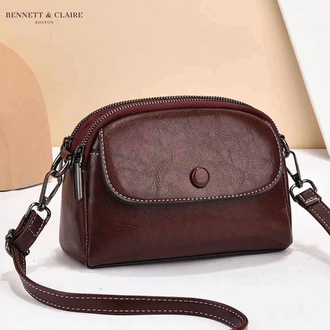 Deep burgundy-brown version of the crossbody bag, with cream stitching along the flap and the long strap. 3