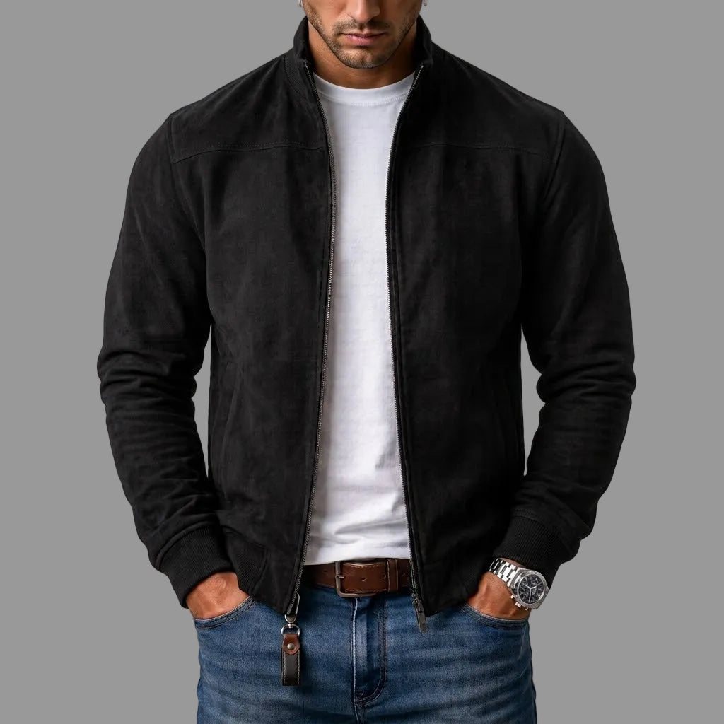 Black suede bomber jacket worn open by a model over a white t-shirt and jeans, with a leather zip pull. 1