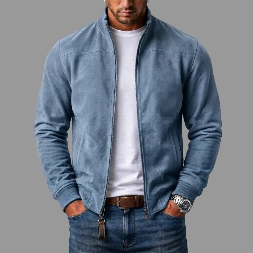 Light blue suede bomber jacket on a model, unzipped over a white t-shirt, with a leather tab on the zip. 4