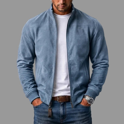 Light blue suede bomber jacket on a model, unzipped over a white t-shirt, with a leather tab on the zip. 4