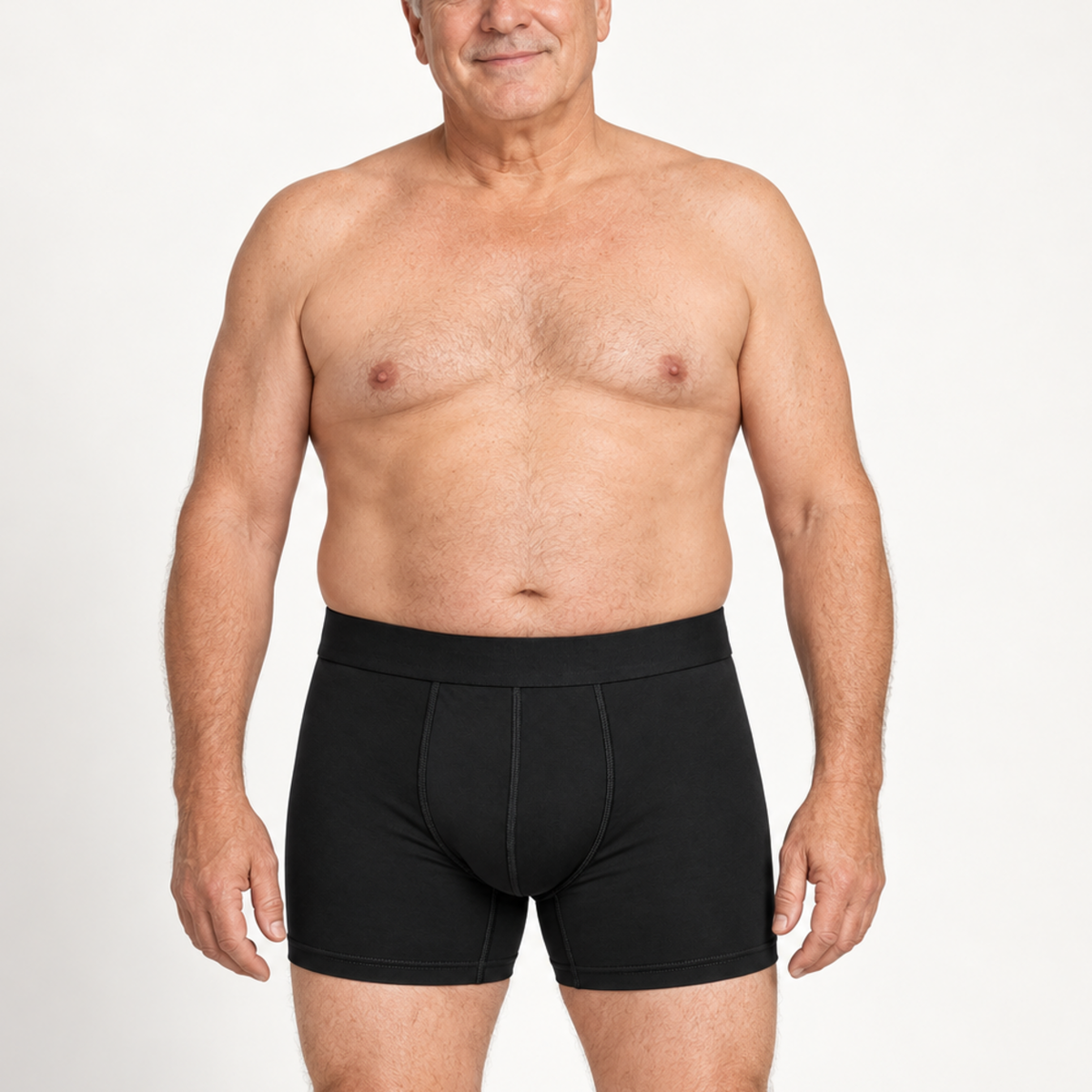 Smiling older shirtless model facing the camera in black boxer briefs with a wide waistband and stitched front panel. 2