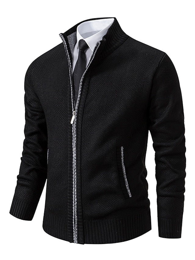 Black version of the zip-up cardigan with grey contrast piping on the zip and pockets, worn over a shirt and tie. 2