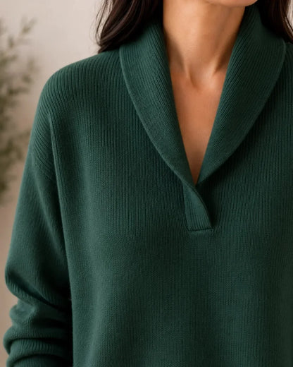 Close-up of the dark green jumper's shawl collar and V-neckline, showing the fine ribbed knit texture. 5