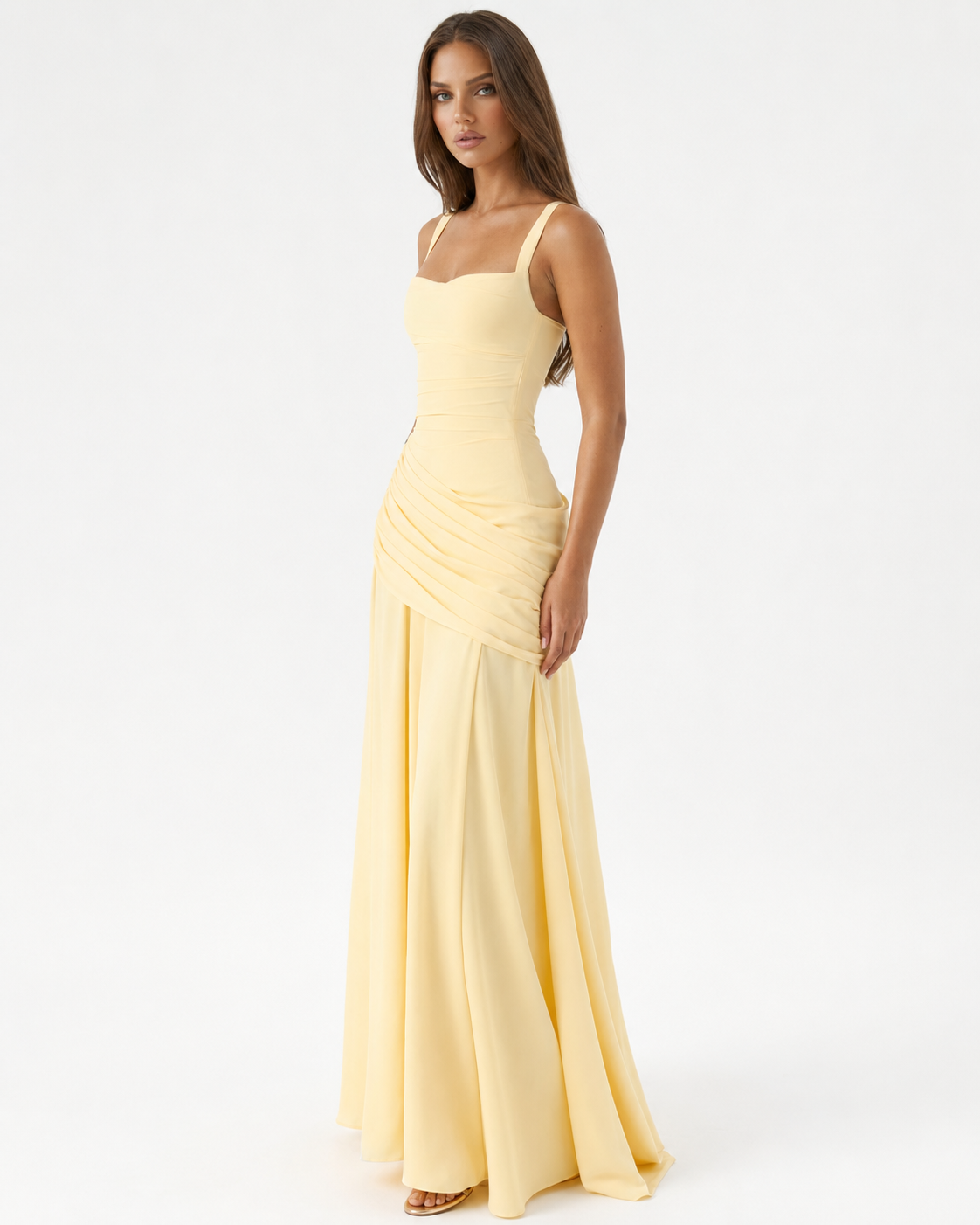 Pale yellow dress worn by a model, three-quarter view showing the square neckline, wide straps and draped hip. 2