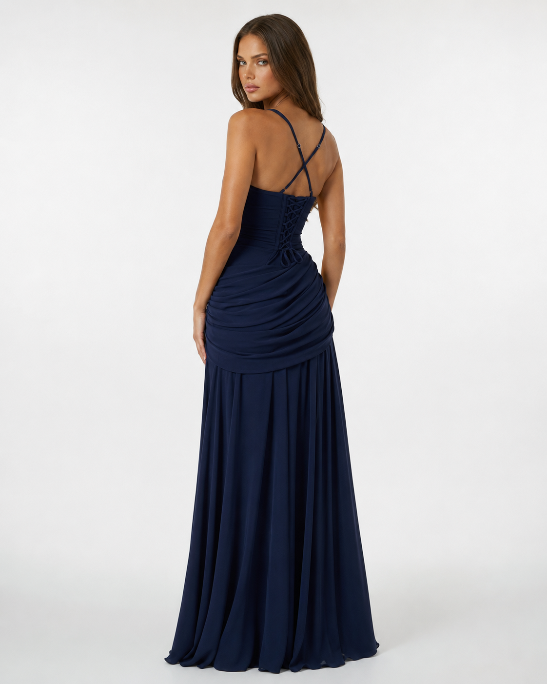 Back view of the navy dress with crossed straps, corset-style lacing and draped hip panel. 8