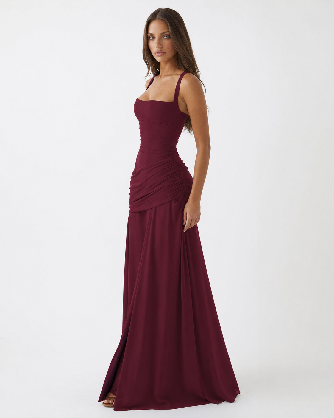 Burgundy maxi dress on a model from the front three-quarter angle, showing square neckline and gathered hip drape. 9