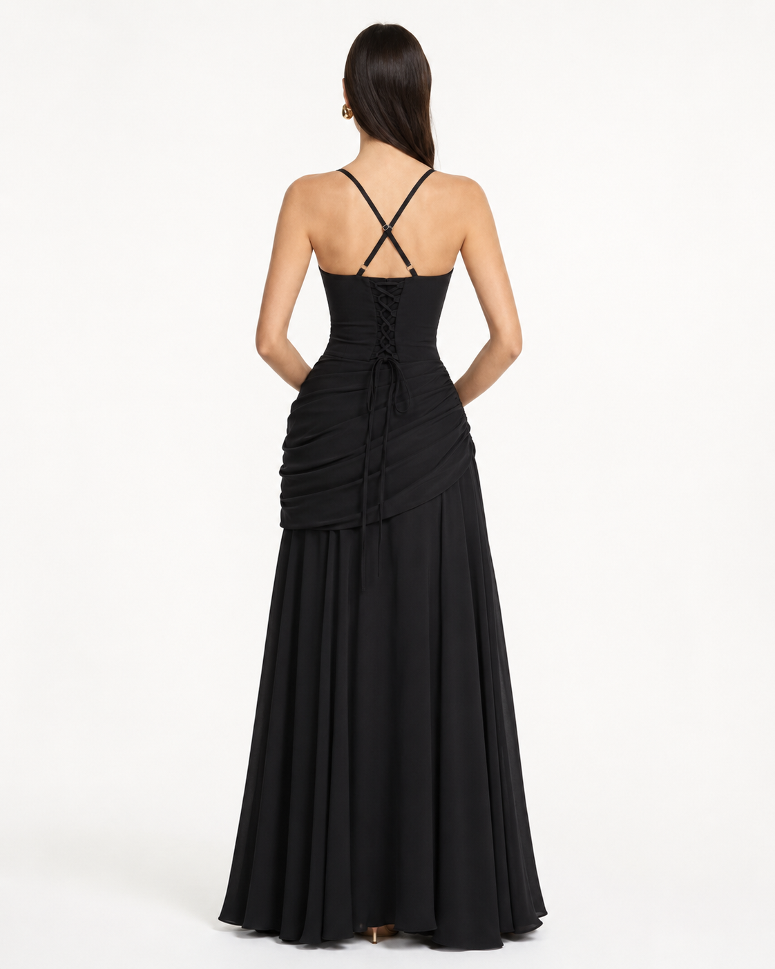 Back view of the black dress with crossed straps, lace-up corset back and draped hip. 14
