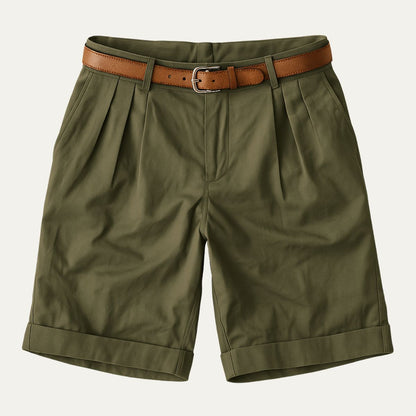 Olive green pleated shorts with turn-up hems, laid flat from the front with a tan leather belt. 13